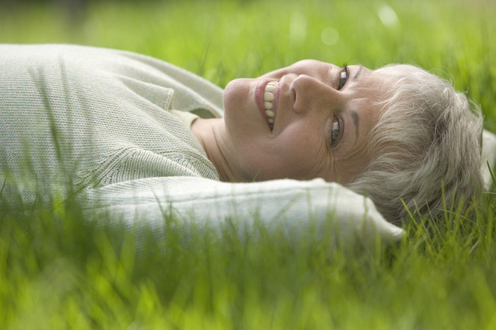 Carefree Woman Lying in the Grass